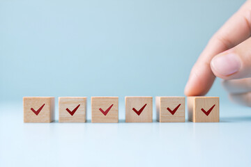 Completion of tasks shown with wooden blocks marked with check marks and human hand
