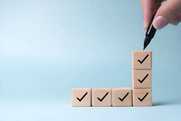 Ascending Wooden Blocks with Checkmarks Symbolizing Project Approval and Completion Stages