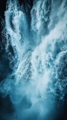 Stunning Aerial View of a Powerful Waterfall Cascading Downwards, Creating a Whirlwind of Water and Mist in a Breathtaking Natural Landscape