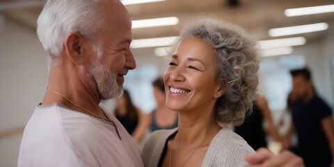 A man and woman are dancing together in a room. The man is smiling and the woman is smiling as well. Scene is happy and joyful