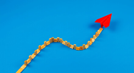 Paper Airplane's Ascent: A striking visual of a paper airplane soaring upwards, tracing a dynamic path against a vivid blue backdrop, symbolizing progress and aspiration.