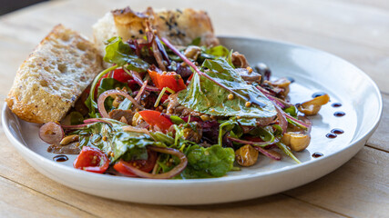 meat salad, bacon, egg, crouton, lettuce, salad dressing vinaigrette  saladcopy space food background rustic top view