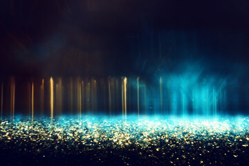 Plakat abstract glitter blue and gold lights background. de-focused