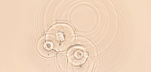 water texture ripples wave clean transparent water abstract background in beige color