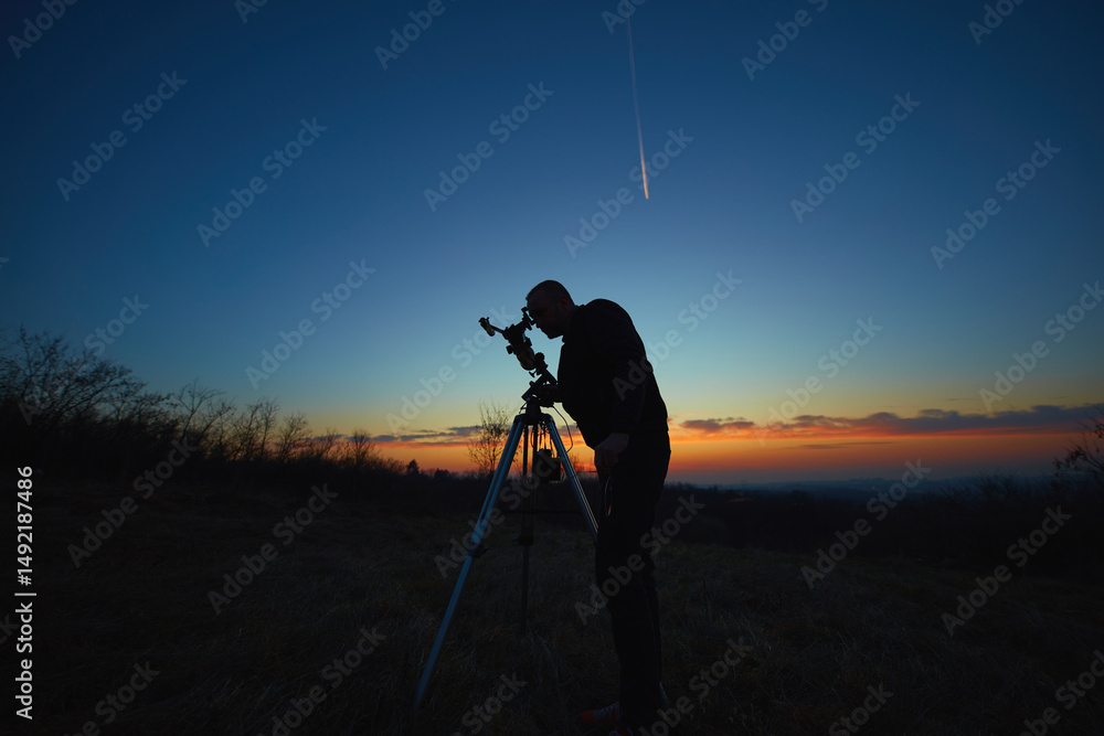 Wall mural amateur astronomer using telescope for watching stars, moon, planets and other celestial objects fro