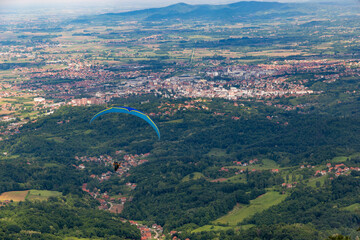 Paraglider taking off over the countryside