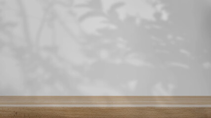 shadow of the trees gently swaying in the breeze, on a white background with a wooden table.