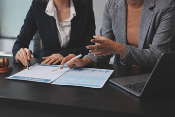 Judge gavel with Justice lawyers having team meeting at law firm background. Concepts of Law and Legal services.