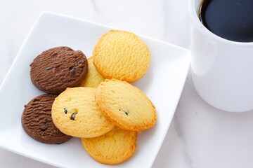 Delicious Cookies on white plate with cup of Coffee
