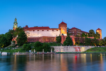 Evening View of Wawel Castle Reflected in Vistula Waters in Cracow , Poland