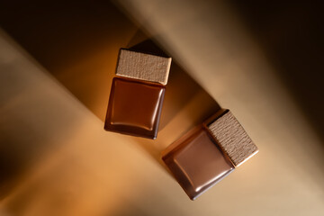 the perfume fragrance cosmetic mockup, luxury product branding, two square bottles with wooden cap, bottle container glass with caustic shadows on dramatic beige background