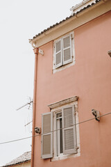 Peach-Colored Building with Shuttered Windows