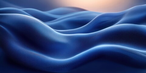 Obraz premium Smooth flowing blue fabric with soft curves and gentle highlights creating an abstract and calming wave-like pattern under warm lighting