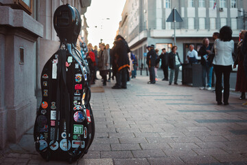 A cello case on a city sidewalk