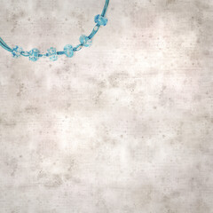 textured stylish old paper background, square, with a simple necklace of blue and transparent glass...