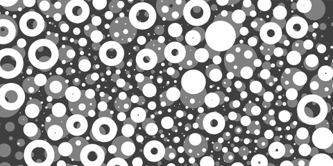 A monochromatic abstract pattern of bright white overlapping circles and rings with varying sizes, forming a textured and dynamic design on a dark background.