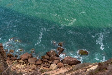 Fototapeta na wymiar Aerial view of rocky coastline with turquoise waters.