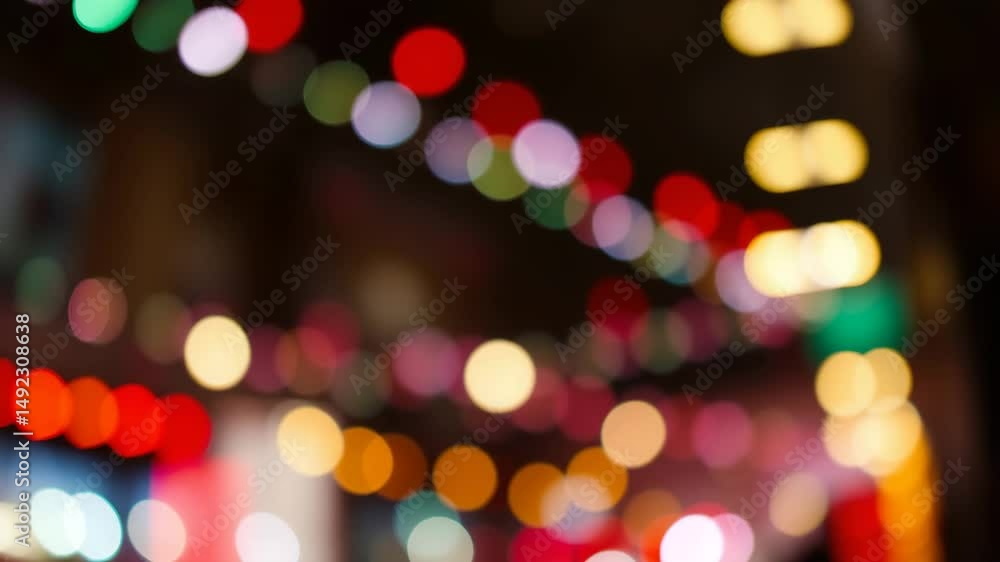 Poster a video showing vibrant blurred lights shining in darkness creating an abstract and colorful spectac