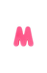 Colored clay shaped like the English letter M. Pink color
