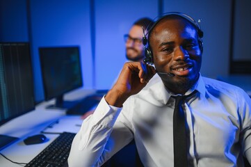 Happy Confident Technical Customer Support Specialist Having a Headset Call in a Monitoring and...
