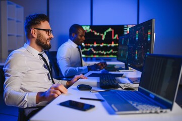 Financial Analyst Talking to Investment Banker in the Evening at Work.