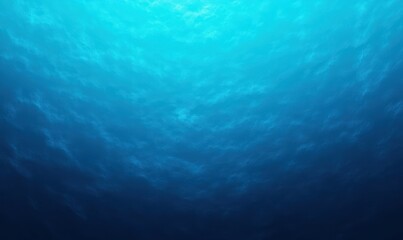 View of the ocean underwater with sunlight penetrating from above creating a gradient of blue hues and a serene, tranquil atmosphere