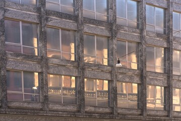 Old facade reflected in a glass facade.
