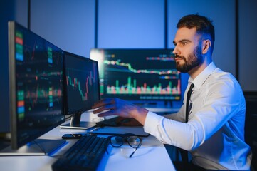 Crypto trader investor analyst looking at computer screen analyzing financial graph data