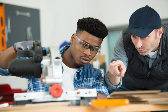 apprentice and teacher during electronic wood cutting machine