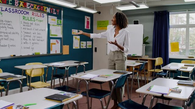 Enthusiastic teacher stands in front of a classroom, actively engaging with students while discussing classroom rules