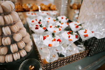 Elegant dessert display featuring whipped cream, strawberries, and treats at a celebration