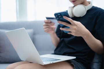 Woman holding credit card and mobile phone