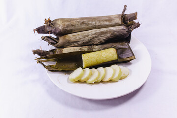 Slices of Lontong or rice cake, indonesian rice dish wrapped in banana leaves, compressed steam rice