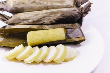 Slices of Lontong or rice cake, indonesian rice dish wrapped in banana leaves, compressed steam rice