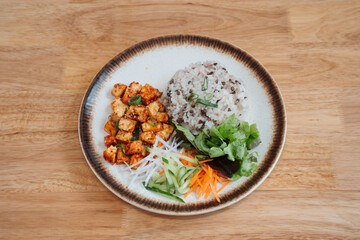 brown rice fried chicken cubes and vegetables. Delicious freshly prepared meal, perfect for menus, restaurants, or food delivery concepts.