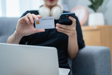 Woman holding credit card and mobile phone