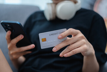 Woman holding credit card and mobile phone