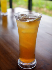 selective focus of iced lemon tea in a glass on wooden table. Close up of iced lemon tea