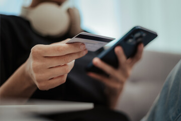 Woman holding credit card and mobile phone