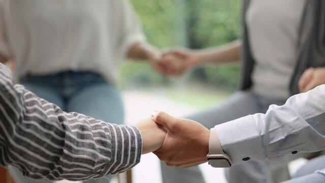Group go green team people hold hands sitting circle at ESG office eco workshop class. Save the planet earth world net zero SDGs help mental health social issues. Unity trust huddle in future hope