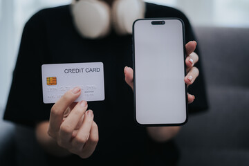 Woman holding credit card and mobile phone
