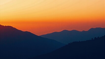 Mountain Range Silhouette Against Sunset Sky