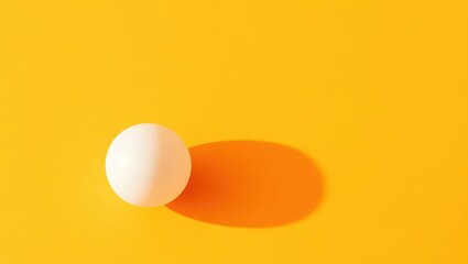 White sphere resting on vibrant yellow surface casting a soft shadow in a minimalistic artistic arrangement Generative AI