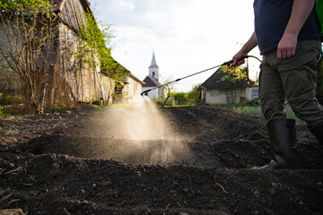 Farmer spraying fertilizer.  Pest control and plant diseases to obtain a large harvest