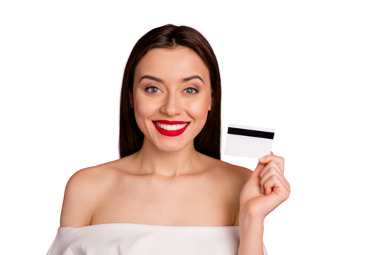 Close up photo of attractive lady with toothy smile holding credit card isolated over red background