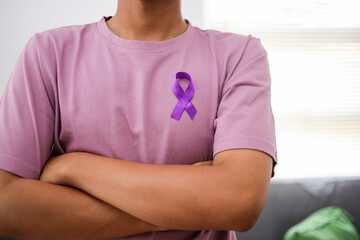 Young Man with Purple Ribbon. Pancreatic Cancer Awareness Concept.