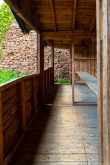 Rustic wooden shelter with weathered walls and lush greenery outside in a peaceful rural setting