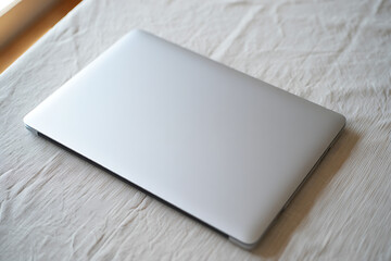 Fototapeta premium Silver Laptop on Beige Fabric