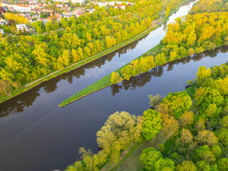 An aerial view captures the meeting of the Vltava and Labe rivers near Melnik, Czechia. Lush...
