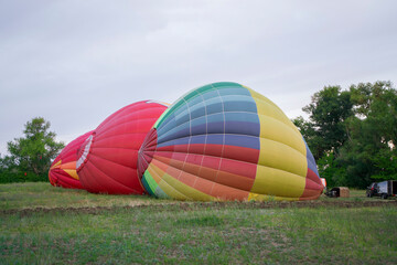 Obraz premium Colorful aerostat balloons are being inflated on the ground